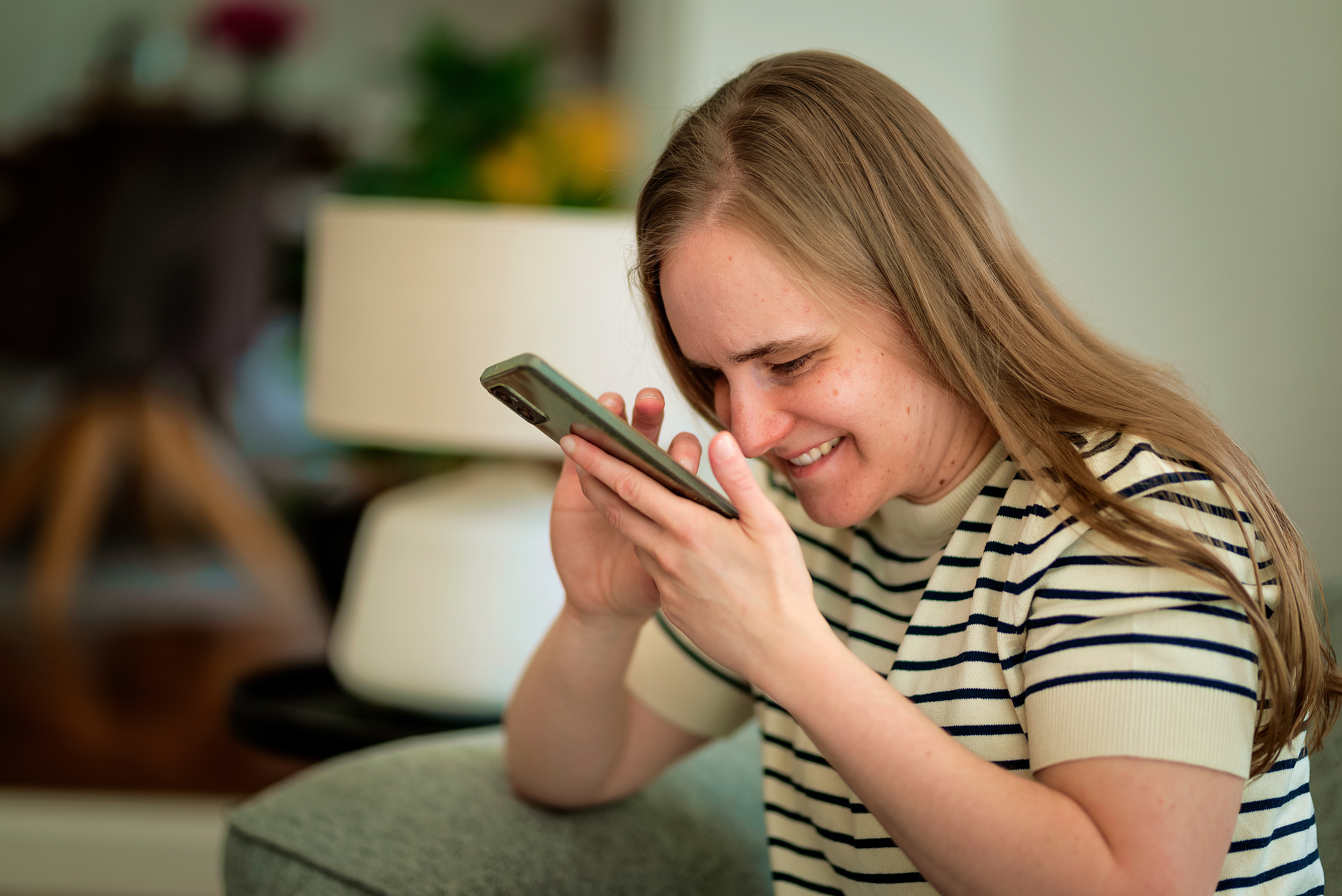 A woman with low vision uses her smartphone